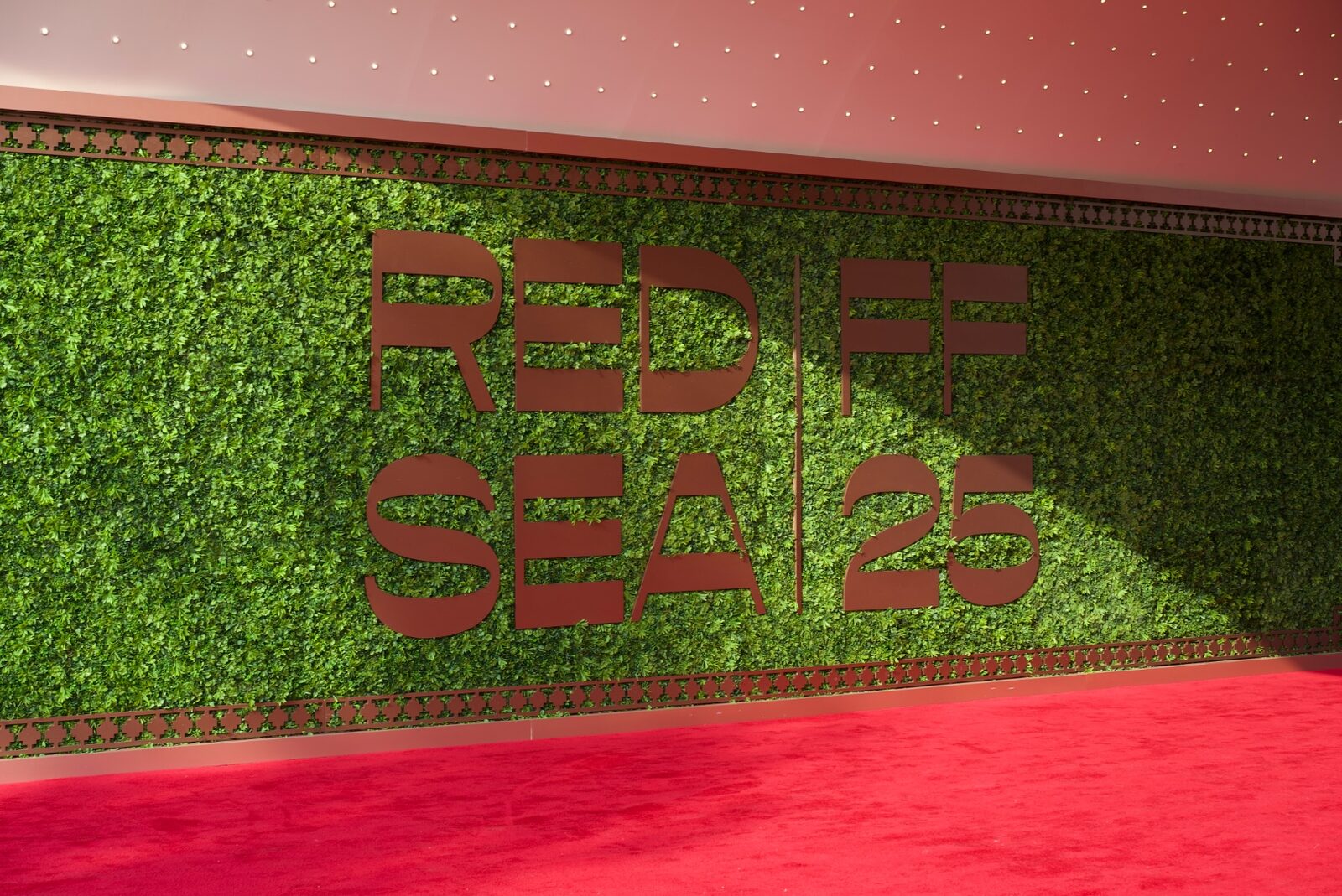 Red Sea International Film Festival 2025 — outdoor signage on greenery wall.
